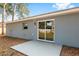 The backyard features a patio and a sliding glass door leading inside at 13300 Sw 105Th Pl, Dunnellon, FL 34432