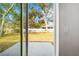 View of the expansive backyard from the home's sliding glass doors and a concrete patio at 13300 Sw 105Th Pl, Dunnellon, FL 34432