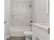 Updated bathroom features a tiled shower-tub, quartz vanity, and modern fixtures at 13300 Sw 105Th Pl, Dunnellon, FL 34432