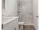 Modern bathroom with marble tiled walk-in shower and sleek white vanity at 13300 Sw 105Th Pl, Dunnellon, FL 34432