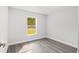 Well-lit bedroom featuring a window and light gray vinyl flooring at 13300 Sw 105Th Pl, Dunnellon, FL 34432