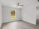 Bright bedroom featuring new vinyl flooring, a ceiling fan, and a bright window at 13300 Sw 105Th Pl, Dunnellon, FL 34432