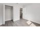A bedroom showing a closet with bi-fold doors, an open door, and gray floors at 13300 Sw 105Th Pl, Dunnellon, FL 34432