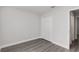 This bedroom features gray floors, white walls, and a closet with bi-fold doors at 13300 Sw 105Th Pl, Dunnellon, FL 34432