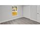 Bright bedroom features a window view, wood-look floors, and closet for ample storage at 13300 Sw 105Th Pl, Dunnellon, FL 34432