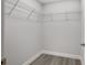 Walk-in closet featuring wire shelving, base trim and gray vinyl floors at 13300 Sw 105Th Pl, Dunnellon, FL 34432