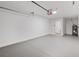Spacious garage features epoxy flooring and a utility closet; water heater is also present at 13300 Sw 105Th Pl, Dunnellon, FL 34432