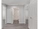 Hallway leading to a bathroom with tiled shower and white fixtures at 13300 Sw 105Th Pl, Dunnellon, FL 34432