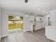 Eat in kitchen area with gray flooring, a backyard view, white cabinetry, and modern lighting at 13300 Sw 105Th Pl, Dunnellon, FL 34432