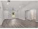 Open living room with new vinyl flooring, white walls, ceiling fan, and easy access to bathroom at 13300 Sw 105Th Pl, Dunnellon, FL 34432