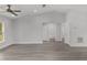 Bright living room featuring vaulted ceilings, gray flooring, neutral paint, and a glimpse of the bathroom at 13300 Sw 105Th Pl, Dunnellon, FL 34432