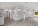 Open concept living room with gray flooring, neutral paint, modern lighting, and vaulted ceilings at 13300 Sw 105Th Pl, Dunnellon, FL 34432