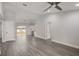Bright living room featuring vaulted ceilings, gray flooring, neutral paint, and white trim at 13300 Sw 105Th Pl, Dunnellon, FL 34432
