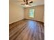 Cozy bedroom with wood-look flooring, a ceiling fan, and a window at 13518 Sw 114Th Ln, Dunnellon, FL 34432