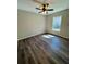 Bright, cozy bedroom with wood-look flooring, a ceiling fan, and a window at 13518 Sw 114Th Ln, Dunnellon, FL 34432
