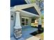 Inviting covered front porch with stone supports and colorful landscaping at 13518 Sw 114Th Ln, Dunnellon, FL 34432