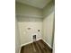Interior laundry room featuring wood-look floor and utilities hookups at 13518 Sw 114Th Ln, Dunnellon, FL 34432