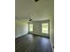 Bright bedroom with neutral walls, a ceiling fan, and large windows overlooking the property's exterior at 1475 Sw Big Bear Rdg, Dunnellon, FL 34431