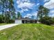 Charming single-story home featuring a well-maintained lawn, attached garage, and classic design at 1475 Sw Big Bear Rdg, Dunnellon, FL 34431