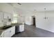 Stylish kitchen with white cabinets, granite countertops, stainless steel appliances and gray laminate flooring at 1475 Sw Big Bear Rdg, Dunnellon, FL 34431