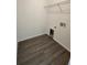 Utility room with laminate floors, white walls, and a space for a washer and dryer at 1475 Sw Big Bear Rdg, Dunnellon, FL 34431