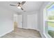 Bedroom with a ceiling fan and a closet has views to the outside at 15067 Sw 16 Pl, Ocala, FL 34481