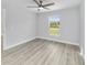 Bedroom with ceiling fan, window and wood-look floors at 15067 Sw 16 Pl, Ocala, FL 34481