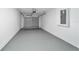 Large gray garage with an automatic door opener and gray epoxy flooring at 15067 Sw 16 Pl, Ocala, FL 34481