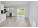 Open living area with views of the kitchen and backyard through sliding glass doors at 15067 Sw 16 Pl, Ocala, FL 34481