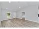 Open-concept living room with modern flooring and ample natural light at 15067 Sw 16 Pl, Ocala, FL 34481