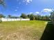 Spacious backyard featuring a well-maintained lawn and a sturdy white fence, perfect for outdoor activities at 15585 Sw 46Th Cir, Ocala, FL 34473