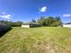 Large backyard showing the homes exterior with a freshly mowed lawn at 15585 Sw 46Th Cir, Ocala, FL 34473