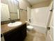 Bathroom featuring vanity, granite countertops, tile flooring, and shower with tub at 15585 Sw 46Th Cir, Ocala, FL 34473