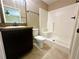Bathroom with a granite countertop vanity, toilet, and tiled walk-in shower at 15585 Sw 46Th Cir, Ocala, FL 34473