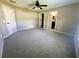 Bright bedroom with en-suite bathroom and closet, fan and neutral carpet at 15585 Sw 46Th Cir, Ocala, FL 34473
