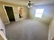 Spacious carpeted bedroom with a ceiling fan, closet and an attached bathroom at 15585 Sw 46Th Cir, Ocala, FL 34473