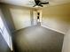Bedroom featuring neutral walls, carpet, ceiling fan, window, and closet at 15585 Sw 46Th Cir, Ocala, FL 34473