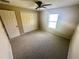 Bedroom featuring neutral walls, carpet, ceiling fan, window, and closet at 15585 Sw 46Th Cir, Ocala, FL 34473