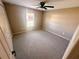 Bedroom featuring neutral walls, carpet, ceiling fan, and a window for natural light at 15585 Sw 46Th Cir, Ocala, FL 34473