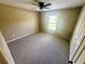 Bedroom featuring neutral walls, carpet, ceiling fan, and a window for natural light at 15585 Sw 46Th Cir, Ocala, FL 34473