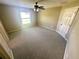 Large bedroom with neutral carpet, ceiling fan, and a window for natural light at 15585 Sw 46Th Cir, Ocala, FL 34473