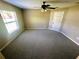 Neutral-toned bedroom with carpet, fan, and natural light from the window at 15585 Sw 46Th Cir, Ocala, FL 34473