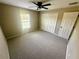 Bedroom featuring neutral walls, carpet, ceiling fan, window, and closet at 15585 Sw 46Th Cir, Ocala, FL 34473