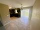 Open dining area with modern light fixture and adjacent to the kitchen with slider to outside at 15585 Sw 46Th Cir, Ocala, FL 34473