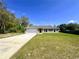 Charming single-story home featuring a two-car garage and a well-manicured lawn at 15585 Sw 46Th Cir, Ocala, FL 34473