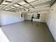 Large garage with sealed floor, overhead storage and utility connections at 15585 Sw 46Th Cir, Ocala, FL 34473