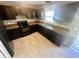 Contemporary kitchen equipped with dark cabinets, granite countertops, and modern appliances for culinary enthusiasts at 15585 Sw 46Th Cir, Ocala, FL 34473