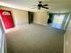 Spacious living room featuring neutral carpet and tile flooring, with an open layout flowing into the dining area at 15585 Sw 46Th Cir, Ocala, FL 34473