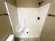 Bright shower with tile surround, built-in seat, and matte black hardware at 15585 Sw 46Th Cir, Ocala, FL 34473
