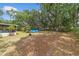 Expansive backyard featuring an above-ground pool, storage shed, and mature trees at 16405 Se 90Th Ct, Summerfield, FL 34491